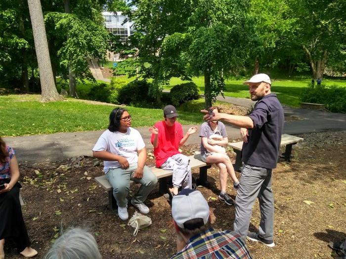 Artist talking to students outside